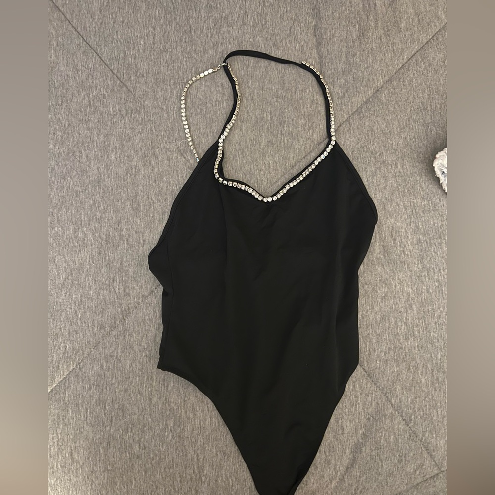 Black bodysuit with chained collar and chain going down back